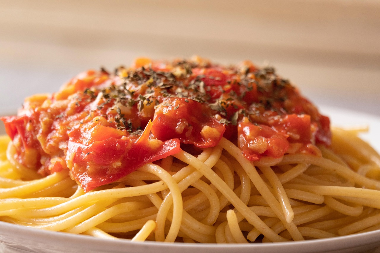 Pasta al pomodoro con sugo fresco, basilico e pomodori maturi in un piatto appetitoso.